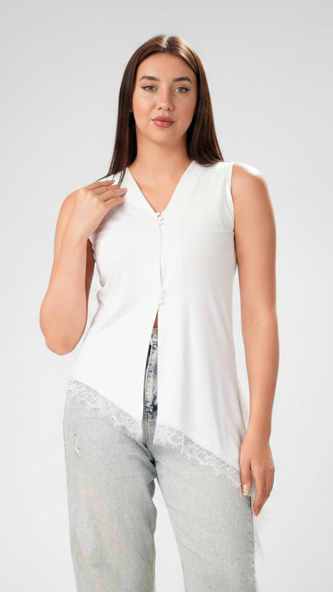 A woman modeling a sleeveless white top with a V-neckline, front button detail, and a frayed hem, paired with light-wash jeans against a light gray studio background.
