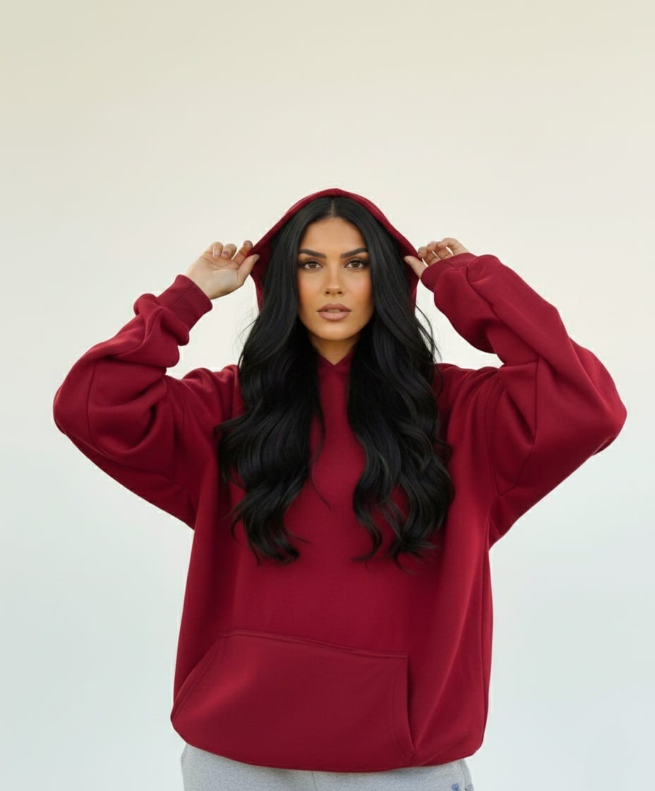 Woman wearing a red hoodie against a plain background