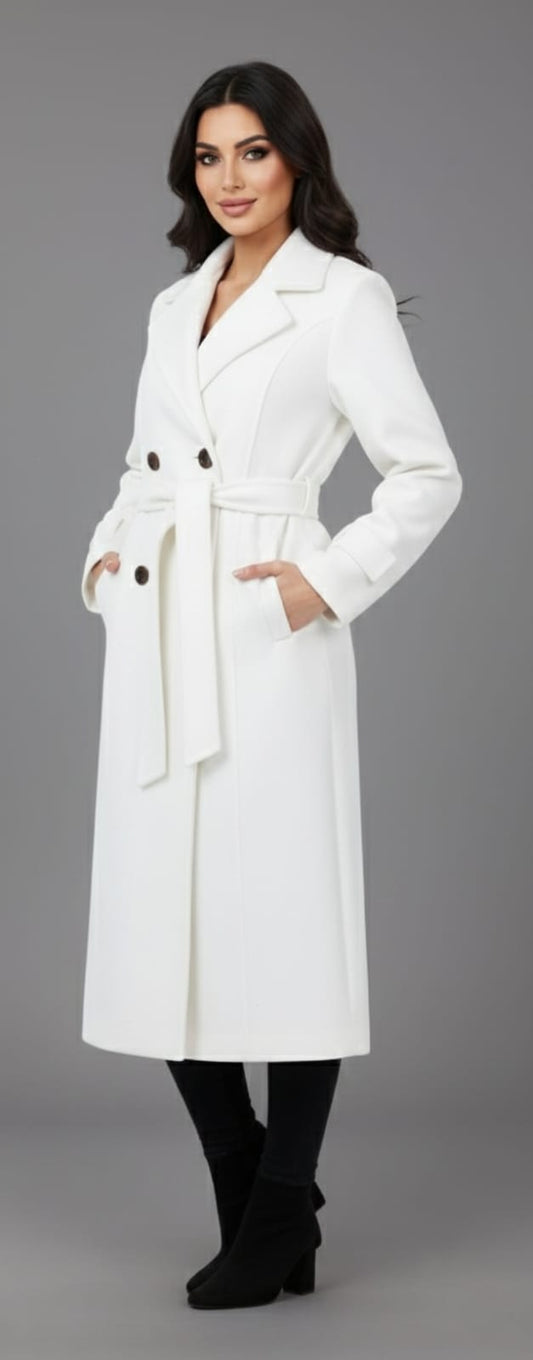 Woman wearing a white coat with black buttons on a gray background